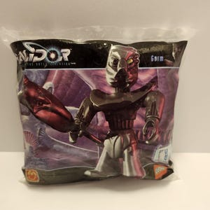 May include: A plastic bag containing a silver and red action figure of a robot with a red weapon. The bag has the words "Zandar: The Battle Begins" and "Gorm" printed on it.