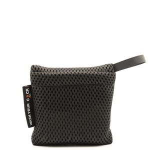 May include: A dark gray mesh pouch with a small loop handle. The pouch has a rectangular label with the text "WASH YOUR C CK" printed vertically in white. The pouch is designed to hold small items.