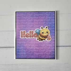 May include: A greeting card with a white border features a cute cartoon bee with the word "Hello" in a decorative font. The bee is brown and yellow with a blue balloon. The background is a gradient of purple and blue.