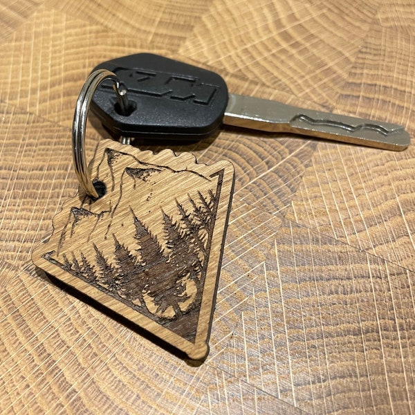 Forrest and mountain range. Laser engraved wooden keyring. Scottish Oak.  Local sustainable sourced timber. Hand finished. Made in Scotland