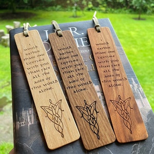 Op de afbeelding: Drie houten bladwijzers met de tekst "Ik zou liever een leven met je delen dan alle tijden van deze wereld alleen onder ogen zien." Elke bladwijzer heeft een andere houttint en een lasergeëtst ontwerp.