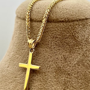 18k Gold Plain cross necklace on display.