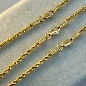 May include: Three gold rope chains of varying lengths with lobster claw clasps.