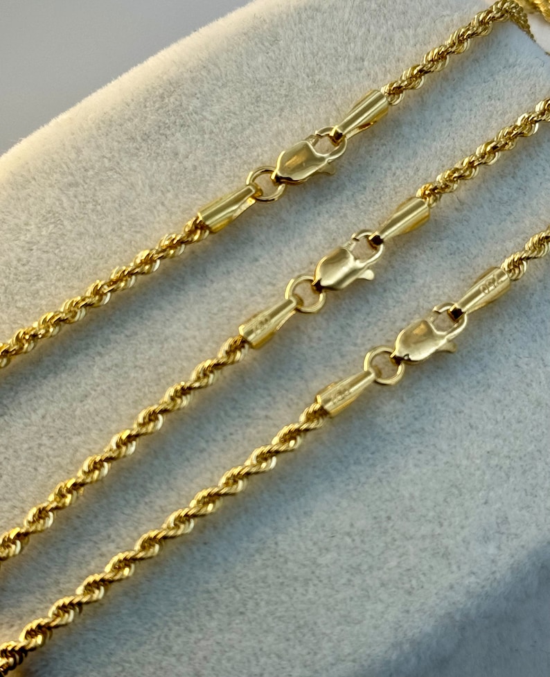 May include: Three gold rope chains of varying lengths with lobster claw clasps.