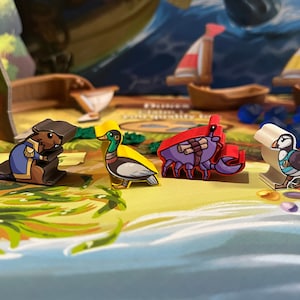 May include: A set of five colourful game pieces featuring a beaver, duck, crab, and puffin. The pieces are made of plastic and have a cartoon-like design. The pieces are on a game board with a blue and green background.