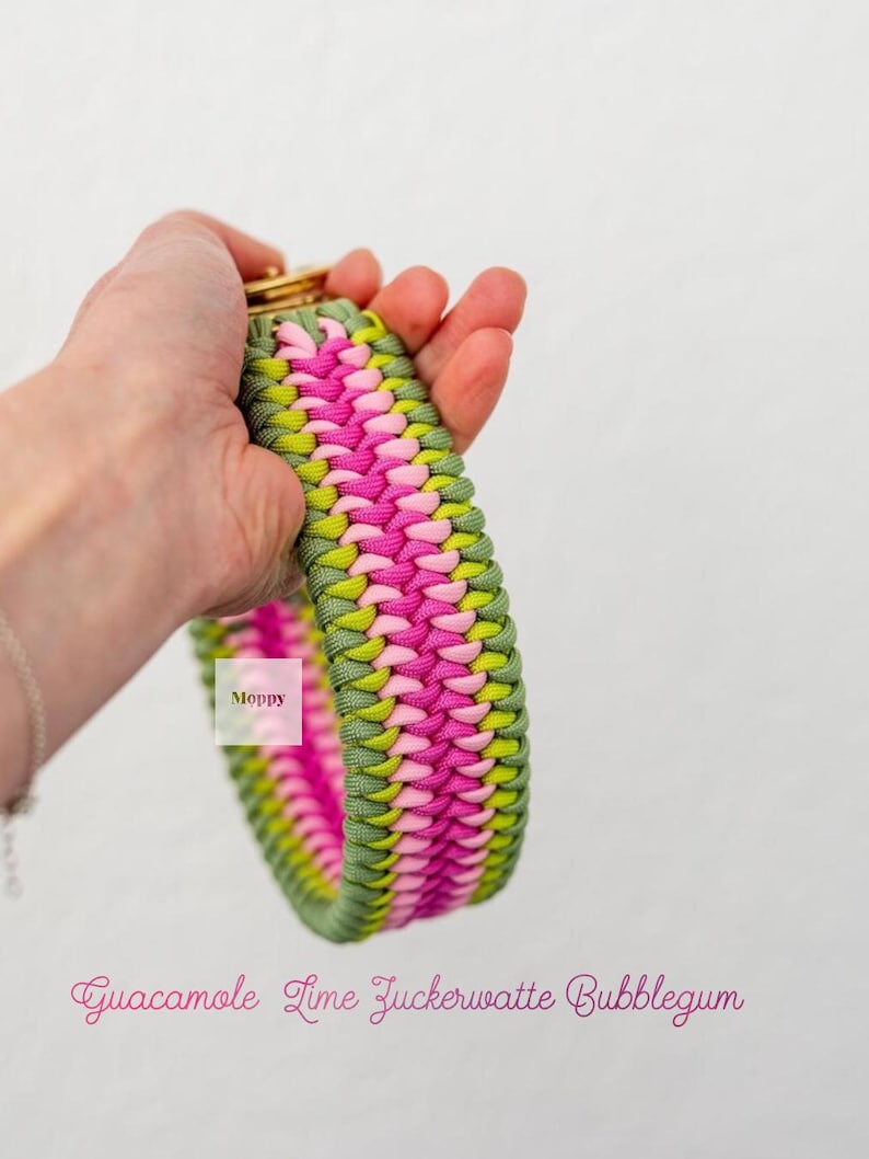 May include: A colorful dog collar in a woven pattern. The collar features a combination of green, pink, and yellow threads. The text "Guacamole Lime Zuckerwatte Bubblegum" is written in pink script.
