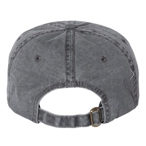 May include: A gray, washed cotton baseball cap with a brown adjustable buckle closure.