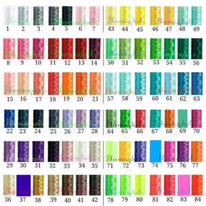 May include: A chart of 84 different colors of embroidery floss, arranged in rows of seven. The floss is wound around small cardboard spools. The spools are labeled with numbers 1 through 84.