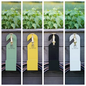 May include: Four hose holders in green, yellow, black, and white, each with a brass faucet design and the "LIVIO" logo. The holders are mounted on a wooden fence with a garden backdrop and a coiled hose at the bottom.
