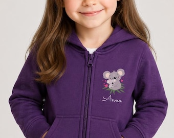 May include: A deep purple zip-up hooded sweatshirt featuring a graphic of a koala holding a baby koala on the left chest. The graphic includes small pink hearts and green leaves. The name Anna is printed in white cursive script below the koala graphic.