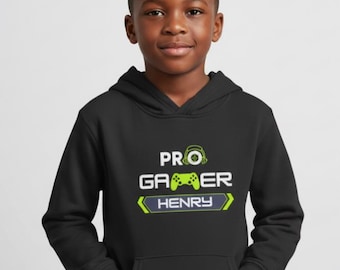 May include: A black hoodie with a front pocket. The hoodie features the text "PRO GAMER HENRY" in white and green, with a controller and headset graphic. The boy is wearing the hoodie.