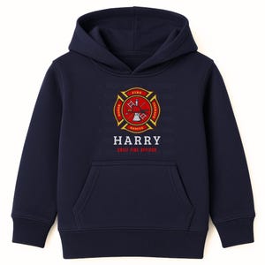 May include: Navy blue hoodie with a front pocket. It displays a red and gold firefighter emblem, the name "HARRY", and "CHIEF FIRE OFFICER" printed underneath. A classic design.