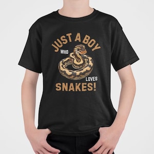May include: Black t-shirt with a graphic of a snake and the text "JUST A BOY WHO LOVES SNAKES!". The snake is brown and tan, coiled in a circle. The text is in a distressed, vintage style.