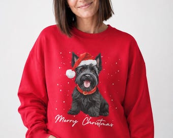 May include: A bright red crewneck sweatshirt featuring a graphic of a black Scottish Terrier wearing a red Santa hat and a red collar. The design includes white snowflakes and the white cursive text Merry Christmas printed below the dog.