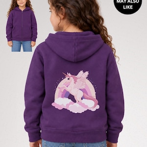 May include: A purple zip-up hoodie featuring a graphic on the back of a white winged unicorn standing on pink clouds in front of a rainbow. A smaller inset image shows the front of the same purple hoodie. The text YOU MAY ALSO LIKE is visible.