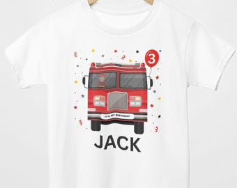 May include: White t-shirt featuring a red fire truck graphic with the text "JACK" below. A red balloon with the number "3" floats above the truck. The shirt also has the text "IT'S MY BIRTHDAY".