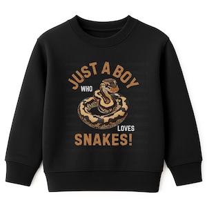 May include: Black sweatshirt with the text "JUST A BOY WHO LOVES SNAKES!" in brown lettering. The graphic features a coiled snake in shades of brown and tan.