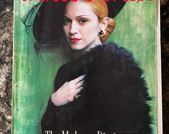 May include: A magazine cover featuring Madonna in a black fur coat and hat. The cover reads "Vanity Fair" and "The Madonna Diaries" with the date "November 1996".