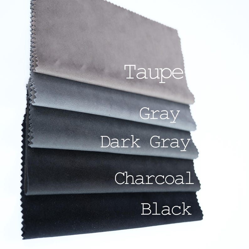 May include: A stack of five rectangular fabric swatches with pinked edges, arranged in a gradient from light to dark. The colors are labeled with white text as Taupe, Gray, Dark Gray, Charcoal, and Black, showcasing a smooth, matte texture.