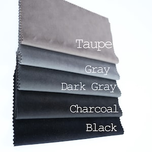 May include: Five fabric swatches in different shades of grey, from light taupe to black. The swatches are labelled "Taupe", "Grey", "Dark Grey", "Charcoal", and "Black".