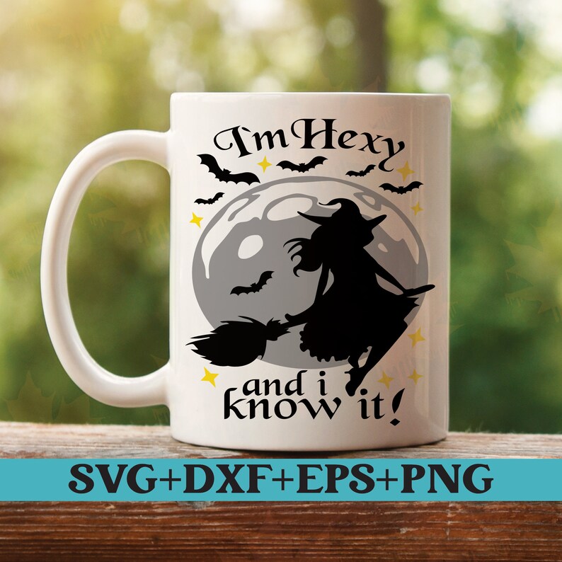 May include: White ceramic mug with a black silhouette of a witch flying on a broomstick in front of a full moon. The text "I'm Hexy and I know it!" is printed on the mug.