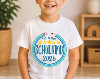 May include: White t-shirt with a circular graphic featuring the text "ERSTKLASSIG SCHULKIND 2026" in blue and white, with yellow stars and pencil illustrations. The bottom of the shirt has the text "SVG | PNG | DXF | STUDIO3 | EPS".