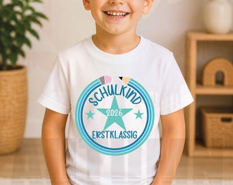 May include: A white t-shirt featuring a circular design with the words "SCHULKIND 2026 ERSTKLASSIG" in blue and teal. The design includes a star and pencil illustrations. The bottom of the image shows the text "SVG | PNG | DXF | STUDIO3 | EPS".