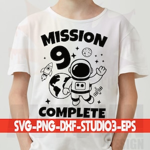 May include: White t-shirt with a black graphic design featuring an astronaut, rocket, planet Earth, and the text "MISSION 9 COMPLETE." Additional text at the bottom reads "SVG-PNG-DXF-STUDIO3-EPS."