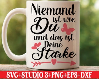 May include: White ceramic mug with a black and pink design. The text on the mug reads "Niemand ist wie Du und das ist Deine Stärke" which translates to "No one is like you and that is your strength".