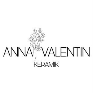May include: A black and white logo featuring the text ANNA VALENTIN in a clean sans-serif font, with the word KERAMIK positioned below. A delicate, thin-lined botanical illustration of a flower stem with leaves is centered between the names.