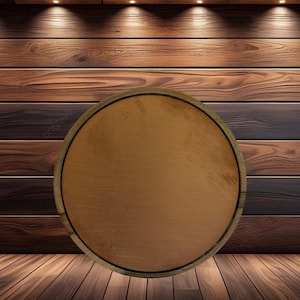 May include: A circular wooden sign with a smooth, light brown center and a darker brown outer rim. The surface of the circle is flat and uniform in color, featuring a natural wood grain texture that is visible across the entire round object.