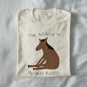 this is my first rodeo - unisex t shirt, funny t shirt, silly t shirt, weird graphic tee, meme cowboy, cowboy meme, horse t shirt,