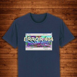 Könnte beinhalten: Marineblaues T-Shirt mit einer Grafik einer Computerfehlermeldung. Das Design zeigt eine simulierte Windows-Oberfläche mit dem Text "ERROR 404" in 3D. Der Hintergrund der Grafik hat ein farbenfrohes, abstraktes Design.