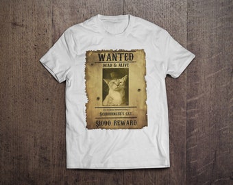 May include: White t-shirt featuring a sepia-toned "Wanted" poster design. The poster includes a cat wearing a hat, the text "DEAD & ALIVE", and "Schrödinger's Cat". The reward is listed as $1000.