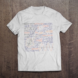 May include: White t-shirt featuring a blue and orange mathematical formula printed on the front. The formula includes graphs, equations, and symbols.