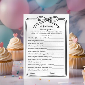 May include: A printable 1st birthday trivia game with a black and white design. The game features questions about the birthday child, such as their favorite food, first word, and zodiac sign. The game includes a space for the player's name and total score.