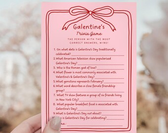 May include: A pink Galentine's Trivia Game card with a bow design at the top. The card features questions about Galentine's Day, with lines for answers. The text reads, "The person with the most correct answers, wins!"