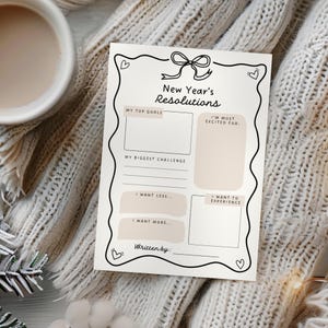 May include: A printable New Year's Resolutions worksheet with sections for top goals, biggest challenge, things to want less of, things to want more of, and what you are most excited for. The worksheet has a black and white design with a pink ribbon and hearts.