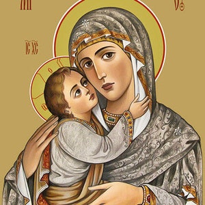 May include: A religious icon depicting the Virgin Mary holding the baby Jesus. The icon is painted in a traditional style with gold accents and intricate details. The Virgin Mary is wearing a blue robe with gold trim and a white veil. The baby Jesus is wearing a white robe and is holding a scroll. The icon is set against a gold background.