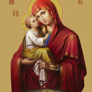 May include: An icon depicting the Virgin Mary holding a baby Jesus. Mary is wearing a red robe with gold trim and a red and gold crown. Jesus is wearing a white robe. The icon is set against a gold background.