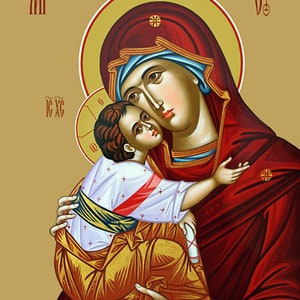 May include: A religious icon depicting the Virgin Mary holding the baby Jesus. Mary is wearing a red robe with a blue head covering. Jesus is wearing a white robe with a gold sash. The icon is painted in a traditional style with gold accents.