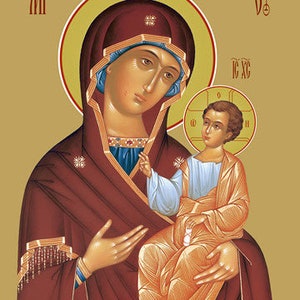 May include: An icon depicting the Virgin Mary holding the baby Jesus. Mary is wearing a red robe with a blue sash and a gold crown. Jesus is wearing a white robe with a gold sash. The background is a gold color.