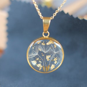 Resin and dandelion pendant, with leaves and gold glitter mounted on a gold-plated chain