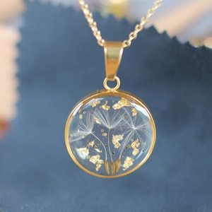 Resin and dandelion pendant, with leaves and gold glitter mounted on a gold-plated chain