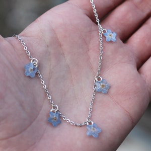 Choker necklace made of real forget-me-not flowers mounted on an adjustable silver stainless steel chain