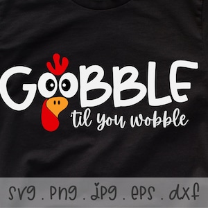May include: Black t-shirt with white text that reads "GOBBLE til you wobble" and a red and yellow turkey head graphic.