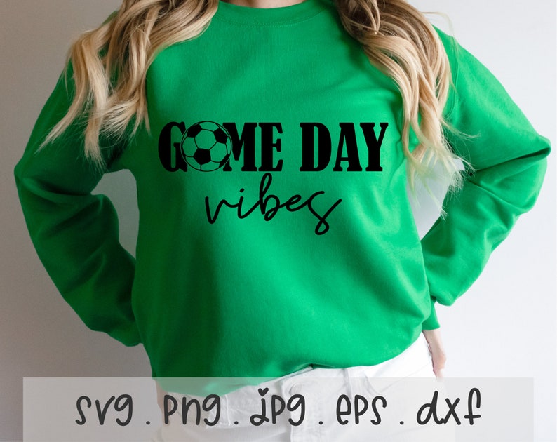 May include: Green sweatshirt with black text that reads "Game Day Vibes" and a black and white soccer ball graphic.