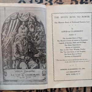 May include: An open book titled The Seven Keys to Power by Lewis de Claremont. The left page features a black and white illustration of a person in a turban and tunic with a spirit guide. The right page lists the author's other book titles.
