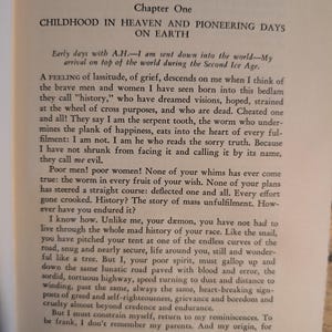 May include: Open book page with text. The title reads "CHILDHOOD IN HEAVEN AND PIONEERING DAYS ON EARTH." The text discusses history, grief, and the human condition. The page is aged with a slightly yellowed tone.