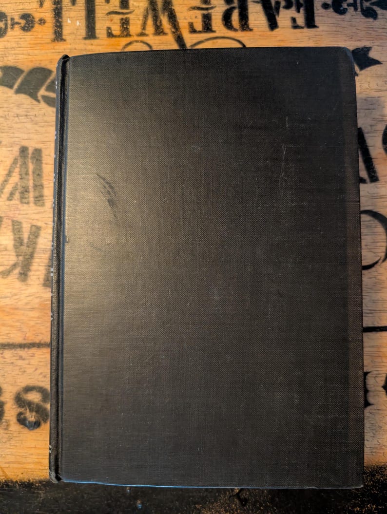 May include: A white ceramic mug with a black handle and the text "But First, Coffee" in a black, handwritten-style font. The mug is on a white surface.